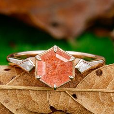 a close up of a ring on top of a leaf