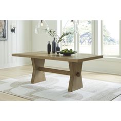 a wooden table sitting on top of a white rug