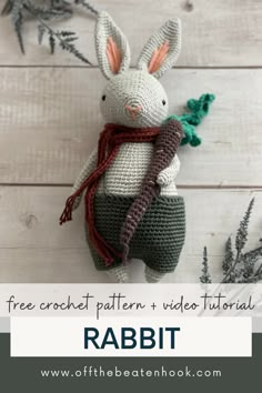 a crocheted stuffed rabbit holding a green branch with text overlay that reads free crochet pattern and video tutor rabbit