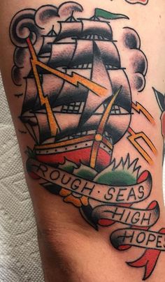 an old school style ship tattoo on the thigh