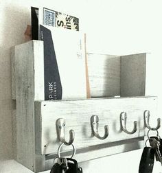 a coat rack with hooks and keys hanging on it