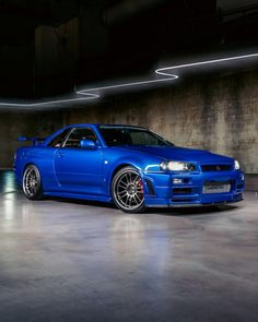 a blue sports car parked in a garage