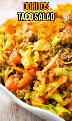 a close up of a bowl of food with the words doritos taco salad