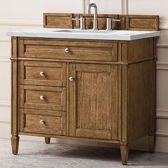 a wooden sink cabinet with two faucets on the top and one drawer below