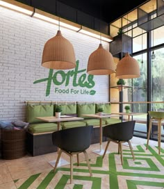 the interior of a restaurant with green and white decor