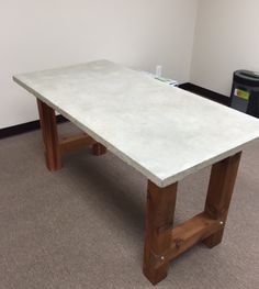 a white table sitting on top of a carpeted floor