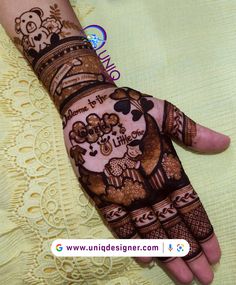 a woman's hand decorated with hennap and pictures on it, showing the intricate design