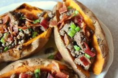 three loaded sweet potatoes on a white plate