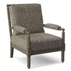 a leopard print upholstered chair with wooden legs and arm rests on an isolated white background