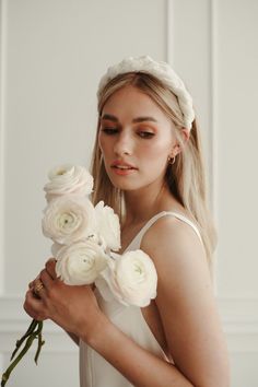 a woman holding flowers in her hands