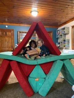 two children are sitting on an inflatable structure