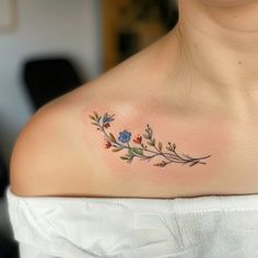 a woman with a flower tattoo on her chest