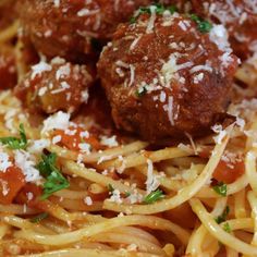 spaghetti with meatballs and parmesan cheese on top