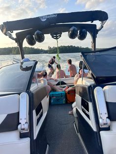 people are sitting on the back of a boat