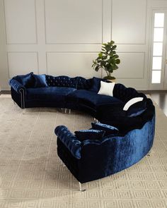 a large blue couch sitting on top of a rug