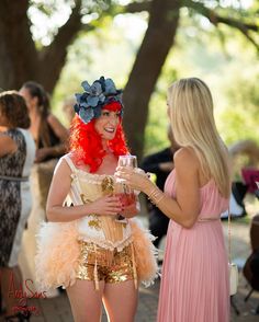 two women dressed in costumes talking to each other