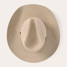 This western-inspired fashion hat brings a welcome pop of Cowboy Core to any look. Its classic silhouette features a 5 1/4" pinch front crown, 4” brim and grosgrain hat band with handmade concho cord accent. Handmade in the U.S.A. with a firm finish from high-quality wool felt, it’s finished with a faux leather sweatband and satin liner for a comfortable, all-day fit. 5 1/4" Pinch Front Crown 4” Brim Grosgrain Hat Band With Handmade Concho Cord Faux Leather Sweatband Satin Liner Firm Finish 100% Classic Fedora With Flat Crown For Western-themed Events, Custom Brimmed Fedora For Ranch, Flat Crown Fedora For Kentucky Derby, Western Style Fedora With Flat Crown, Flat Crown Fedora For Kentucky Derby And Western Events, Rigid Felt Hat With Short Brim For Western-themed Events, Rigid Wide Brim Top Hat For Rodeo, Western Style Curved Brim Felt Hat For Ranch, Flat Crown Felt Hat For Kentucky Derby