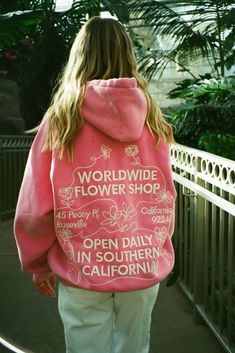 photo shows a blonde teenage girl standing on a bridge. there are lots of plants and greenery in the background. she is wearing cream colored pants and a pink hoodie that says "worldwide flower shop" on the back in embroidery and embroidered graphics of flowers. photo was taken on film Dandy Sweatshirt, Hoodie Wishlist, Dandy Hoodie, Dandy Worldwide, Clothes Wishlist, Cute Clothing Stores, Birthday List, Summer 24, Birthday Wishlist