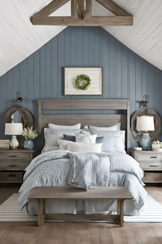 a bedroom with blue walls and white bedding