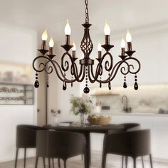 a chandelier hanging over a dining room table