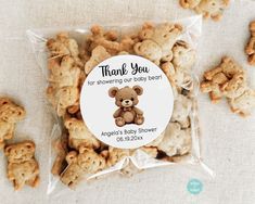 there is a bag of baby shower cookies with a teddy bear on it's label