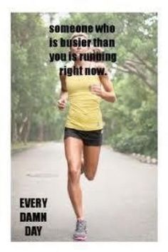 a woman running down a road with trees in the background