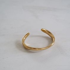 Curved Cuff Bracelet Minimalist Tarnish Resistant Gold Plated Cuff Bracelet, Elegant Adjustable Cuff Rings, Minimalist Adjustable Open Band Bracelets, Minimalist Adjustable Open Band Bracelet, Gold Plated Tarnish Resistant Cuff Bracelet, Tarnish Resistant Gold Plated Cuff Bracelet, Adjustable Gold Cuff Bracelet For Formal Occasions, Gold Minimalist Cuff Bracelet, Gold Plated, Elegant Adjustable Brass Cuff Bracelet