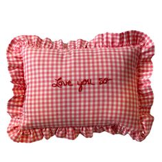 a red and white gingham pillow with the words love you so on it