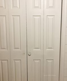 two white closet doors in a small room