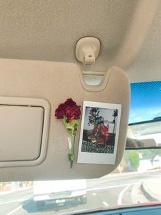 the interior of a car with flowers and pictures on the wall next to the window