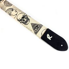 a black and white knife with tattoos on it