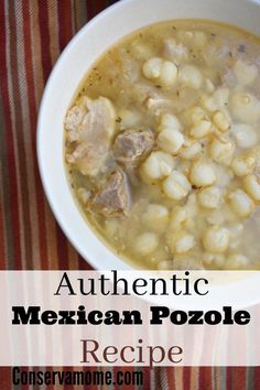 a white bowl filled with mexican pozole soup on top of a striped table cloth