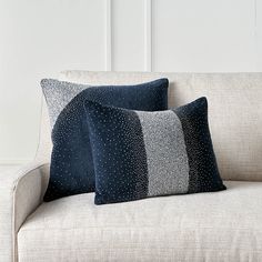 two pillows sitting on top of a couch