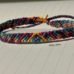 two colorful bracelets sitting on top of a table