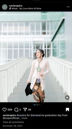 a woman is walking down the stairs with her hand in her pocket and holding a purse