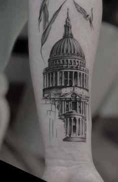 a black and white photo of the capital building tattoo on someone's left arm