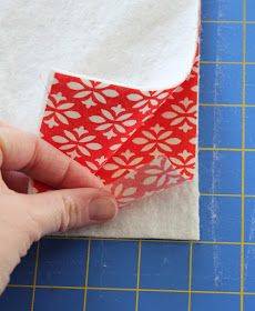 someone is cutting out some fabric on a piece of paper