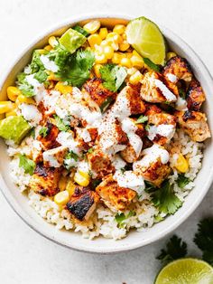 a bowl filled with rice, corn and cilantro on top of a table