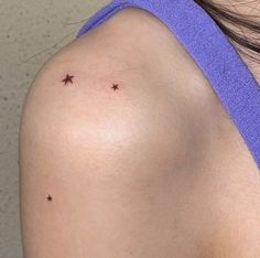 a woman's shoulder with small stars on it