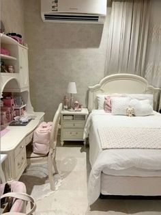 a bedroom with white furniture and pink accessories