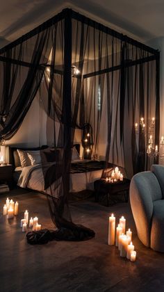 a bedroom with candles lit on the floor