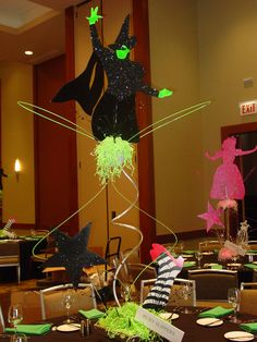 the table is set with green and black decorations