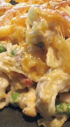 a casserole dish with chicken, peas and cheese