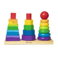 a wooden stacking toy with an apple sitting on top of it, surrounded by colorful blocks