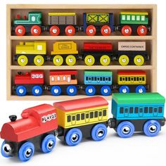 a wooden toy train set sitting in front of a shelf