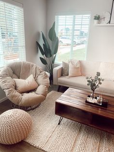 a living room with two couches and a coffee table in front of the window