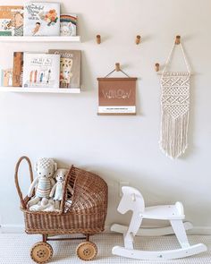 there is a small toy horse next to a wicker chair and bookshelf