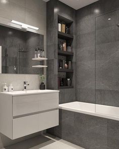 a bathroom with a sink, bathtub and shelves in the wall next to it