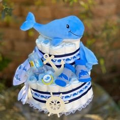 a blue and white baby shower cake with a whale on top