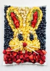 an art piece made out of strawberries and other fruits in the shape of a bunny